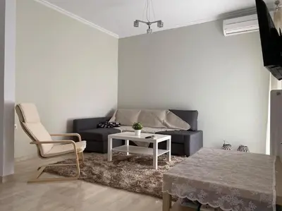 a living room with a couch and a table at The Katehaki Comfort Hub in Athens