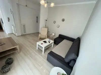 a living room with a couch and a table at The Katehaki Comfort Hub in Athens