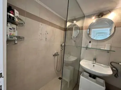a bathroom with a shower and a sink and a mirror at The Katehaki Comfort Hub in Athens