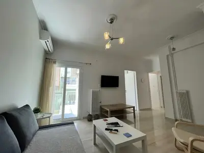 a living room with a couch and a table at The Katehaki Comfort Hub in Athens