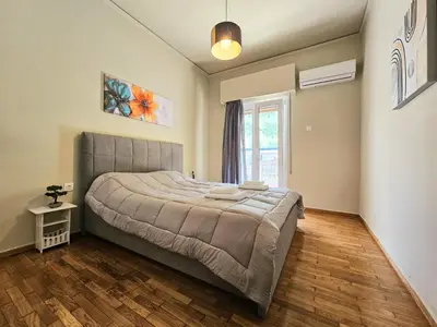 a bedroom with a large bed and a window at EL Prestige Apartment - Athens Town in Athens