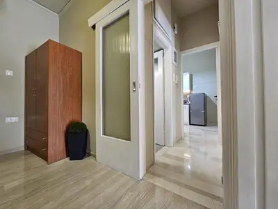 a hallway with a mirror and a dresser in a room at EL Prestige Apartment - Athens Town in Athens
