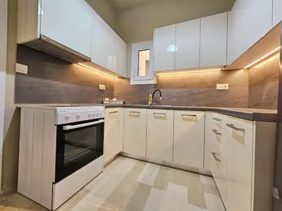 a kitchen with white cabinets and a stove top oven at EL Prestige Apartment - Athens Town in Athens