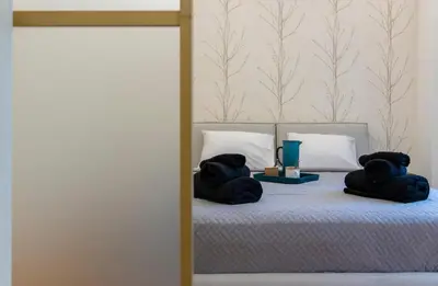 two teddy bears are sitting on a bed with towels at Prime and Cosy 1bedroom Hop to Acropolis in Athens