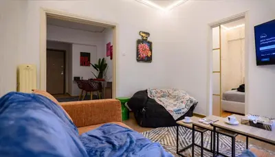 a living room with a couch and a table at Prime and Cosy 1bedroom Hop to Acropolis in Athens