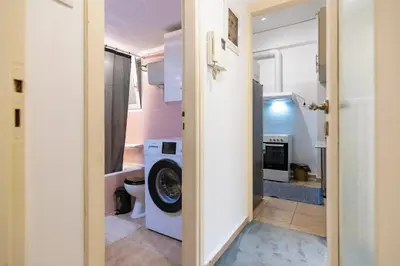 a bathroom with a washer and dryer in a house at Prime and Cosy 1bedroom Hop to Acropolis in Athens