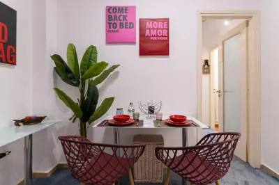 a dining room with a table and chairs and a plant at Prime and Cosy 1bedroom Hop to Acropolis in Athens