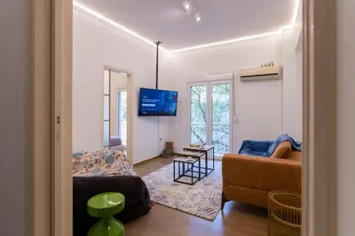 a living room with a couch and a tv at Prime and Cosy 1bedroom Hop to Acropolis in Athens
