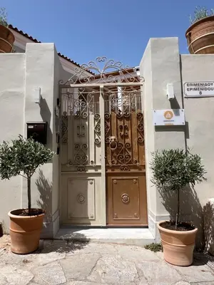 an entrance to a house with a gate and two plants at One-bedroom Suite - Themelio Suites - Acropolis Area in Athens