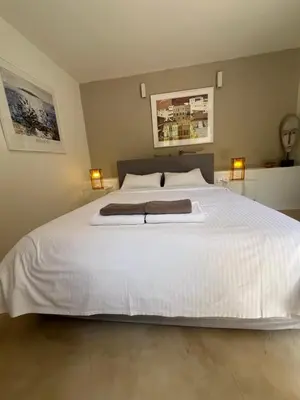a bedroom with a white bed with two towels on it at One-bedroom Suite - Themelio Suites - Acropolis Area in Athens