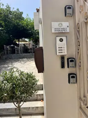 a door with a sign that says please enter the house shuttle at One-bedroom Suite - Themelio Suites - Acropolis Area in Athens
