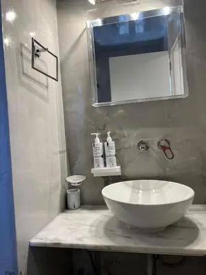 a bathroom with a white sink and a mirror at One-bedroom Suite - Themelio Suites - Acropolis Area in Athens
