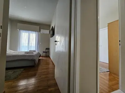 a bedroom with a bed and a room with a door at J&G Luxury Apartment - Athens Town in Athens