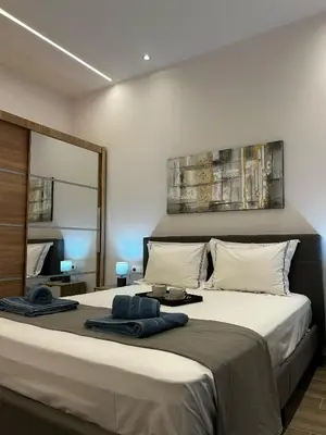 a bedroom with a large bed with towels on it at Mimoza in Athens
