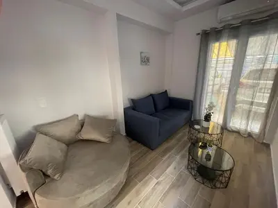a living room with a couch and a chair at Mimoza in Athens