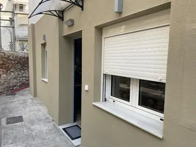 a building with a window with a window blind at Mimoza in Athens