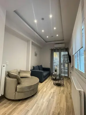 a living room with a couch and a table at Mimoza in Athens