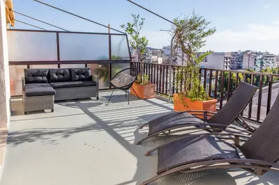 a patio with chairs and a couch on a balcony at Lucas apartment 3 in Athens