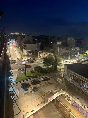 a city at night with cars on a street at Lucas apartment 3 in Athens