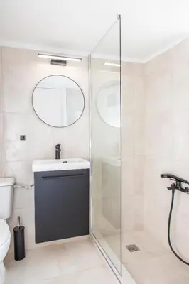 a bathroom with a shower and a sink and a mirror at Lucas apartment 3 in Athens
