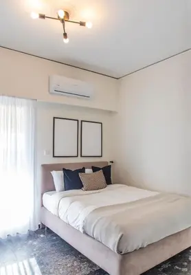 a bedroom with a large bed with a ceiling fan at Lucas apartment 3 in Athens