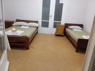 a room with two beds and a door to a window at Room for 2 persons next to metro in Athens