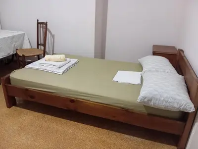 a bed with two pillows on it in a room at Room for 2 persons next to metro in Athens