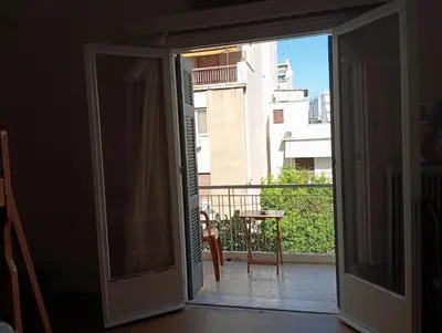 an open door to a balcony with a table at Room for 2 persons next to metro in Athens