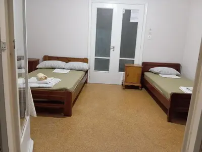 a room with two beds and a door in it at Room for 2 persons next to metro in Athens
