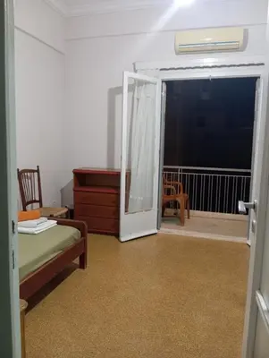 a room with a door open to a room with a balcony at Room for 2 persons next to metro in Athens
