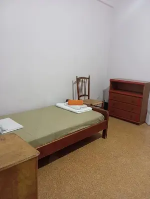 a bedroom with a bed and a dresser and a chair at Room for 2 persons next to metro in Athens