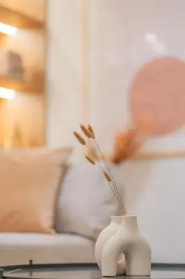 a white vase with flowers in it on a table at Acropolis View Dream Penthouse in Athens