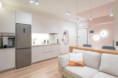 a living room with a couch and a kitchen at Acropolis View Dream Penthouse in Athens