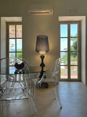 a dining room with a glass table and a lamp at Acropolis View-Themelio Suite - Acropolis Area in Athens