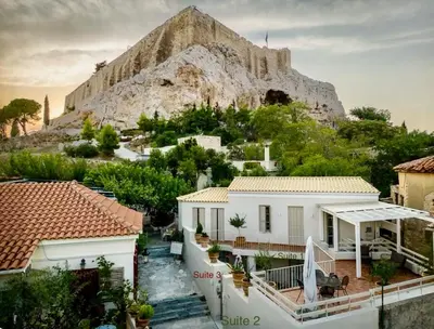a house with a mountain in the background at Two-bedrooms Suite - Themelio Suites - Acropolis Area in Athens