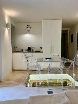 a dining room with a glass table and chairs at Two-bedrooms Suite - Themelio Suites - Acropolis Area in Athens