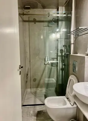 a bathroom with a shower and a toilet and a sink at Two-bedrooms Suite - Themelio Suites - Acropolis Area in Athens