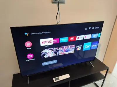 a flat screen tv sitting on top of a table at Modern apt in downtown by MK in Athens