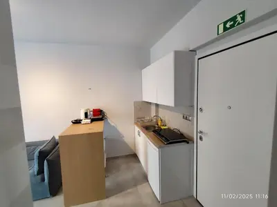 a small kitchen with a counter and a refrigerator at Modern apt in downtown by MK in Athens