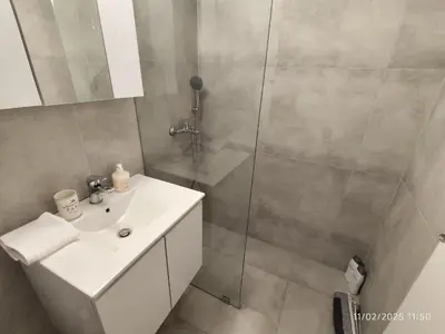 a bathroom with a shower and a sink at Modern apt in downtown by MK in Athens
