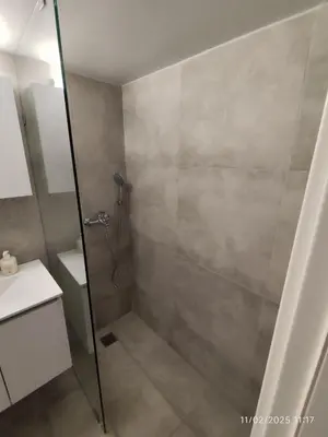 a shower with a glass door in a bathroom at Modern apt in downtown by MK in Athens