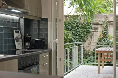 a kitchen with a stove and a balcony at Just Home Cozy Fully Renovated Apt in Athens