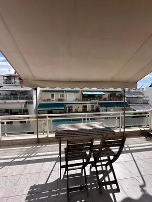 a table and chairs on the roof of a building at Acropolis Loft 26 in Athens
