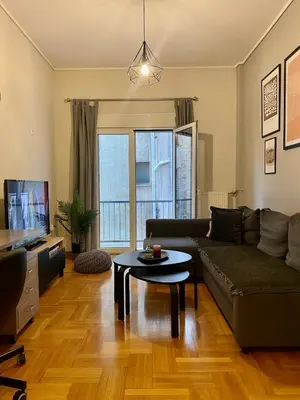 a living room with a couch and a table at In between Syntagma & Plaka in Athens