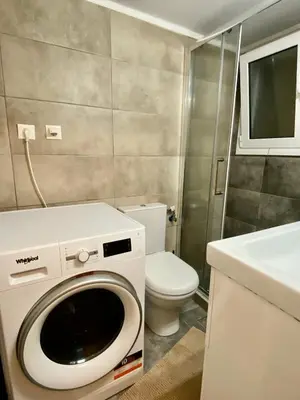 a bathroom with a washing machine and a toilet at In between Syntagma & Plaka in Athens