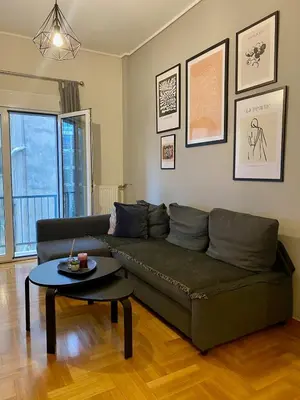 a living room with a green couch and a table at In between Syntagma & Plaka in Athens