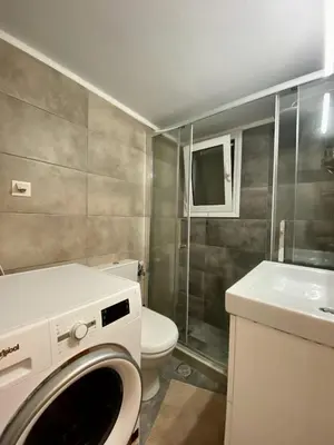 a bathroom with a washing machine and a toilet at In between Syntagma & Plaka in Athens