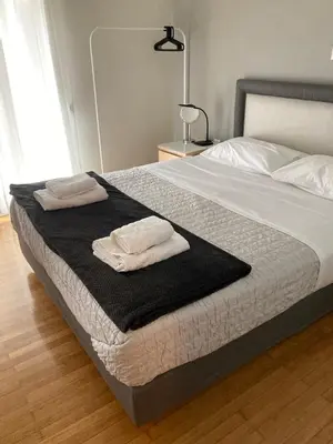a bedroom with a bed with two towels on it at In between Syntagma & Plaka in Athens
