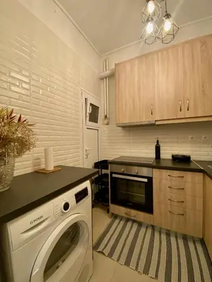 a kitchen with a washing machine in a kitchen at In between Syntagma & Plaka in Athens