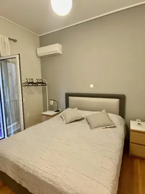 a bedroom with a white bed with pillows on it at In between Syntagma & Plaka in Athens